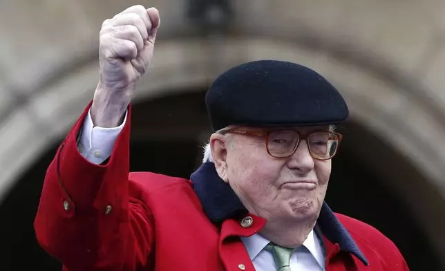 FILE - Former far-right National Front party leader Jean-Marie Le Pen clenches his fist at the statue of Joan of Arc, Monday May 1, 2017, in Paris. (AP Photo/Kamil Zihnioglu, File)