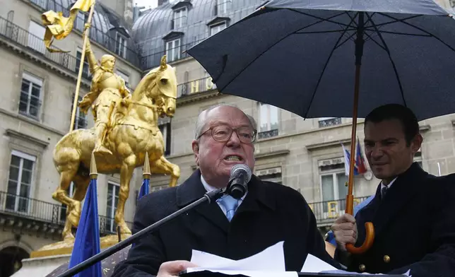 FILE - French far-right politician Jean Marie Le Pen, father of Marine Le Pen, the National Front party candidate for the 2012 French presidential elections delivers a speech in front of a statue of Joan of Arc, to mark the 600th anniversary of her birth, in Paris, Saturday, Jan. 7, 2012.(AP Photo/Francois Mori)