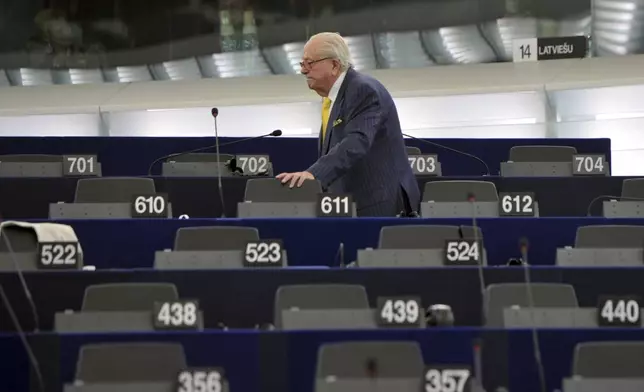 FILE - French former far right National Front leader Jean Marie Le Pen looks for his seat at the European Parliament, in Strasbourg, eastern France, July 1, 2014. (AP Photo/Christian Lutz, File)