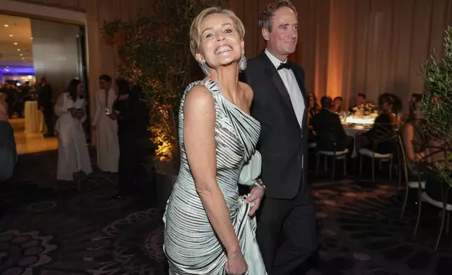 Sharon Stone, left, and Jim Osborne arrive at the 82nd Golden Globes on Sunday, Jan. 5, 2025, at the Beverly Hilton in Beverly Hills, Calif. (AP Photo/Chris Pizzello)