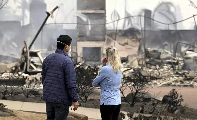 Hastings Ranch resident Patricia Vahdat, right, and a neighbor speak in front of another one of her neighbors home which was completely destroyed by the Eaton fire in the Hastings Ranch community of Pasadena early Wednesday morning Jan. 8, 2025.(Will Lester/The Orange County Register via AP)