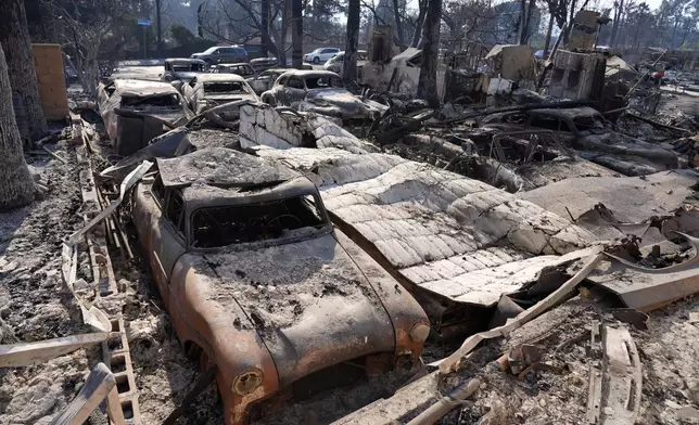 Burned-out cars sit amongst debris at a residence on Altadena Drive destroyed by the Eaton Fire, Friday, Jan. 10, 2025, in Altadena, Calif. (AP Photo/Chris Pizzello)