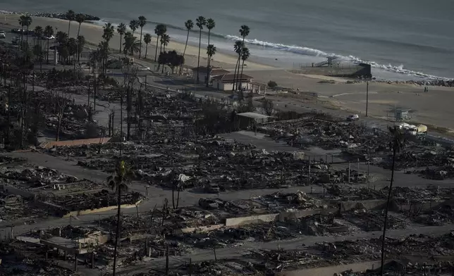 Rows of residences are burned to the ground in the aftermath of the Palisades Fire in the Pacific Palisades neighborhood of Los Angeles, Friday, Jan. 10, 2025. (AP Photo/Eric Thayer)