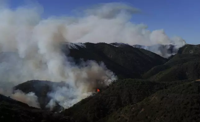 The Palisades Fire continues to burn in the outskirts of the Pacific Palisades neighborhood of Los Angeles, Friday, Jan. 10, 2025. (AP Photo/Eric Thayer)
