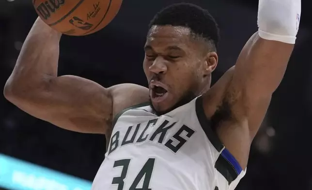 Milwaukee Bucks' Giannis Antetokounmpo dunks during the first half of an NBA basketball game Saturday, Jan. 4, 2025, in Milwaukee. (AP Photo/Morry Gash)