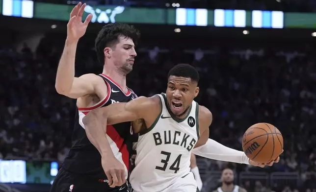 Milwaukee Bucks' Giannis Antetokounmpo gets past Portland Trail Blazers' Deni Avdija during the first half of an NBA basketball game Saturday, Jan. 4, 2025, in Milwaukee. (AP Photo/Morry Gash)