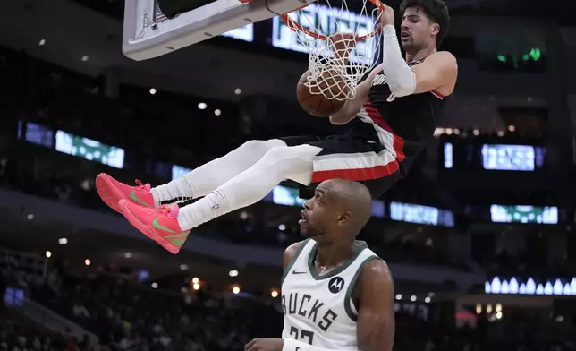 Milwaukee Bucks' Khris Middleton watches Portland Trail Blazers' Deni Avdija dunk during the second half of an NBA basketball game Saturday, Jan. 4, 2025, in Milwaukee. (AP Photo/Morry Gash)