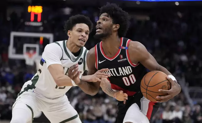 Portland Trail Blazers' Scoot Henderson tries to get past Milwaukee Bucks' Ryan Rollins during the second half of an NBA basketball game Saturday, Jan. 4, 2025, in Milwaukee. (AP Photo/Morry Gash)