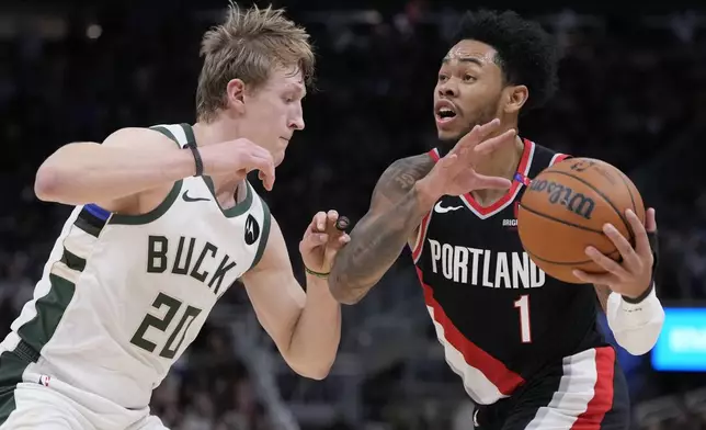 Portland Trail Blazers' Anfernee Simons tries to get past Milwaukee Bucks' AJ Green during the second half of an NBA basketball game Saturday, Jan. 4, 2025, in Milwaukee. (AP Photo/Morry Gash)