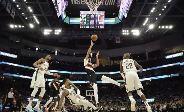 Portland Trail Blazers' Shaedon Sharpe shoots past Milwaukee Bucks' Damian Lillard during the second half of an NBA basketball game Saturday, Jan. 4, 2025, in Milwaukee. (AP Photo/Morry Gash)