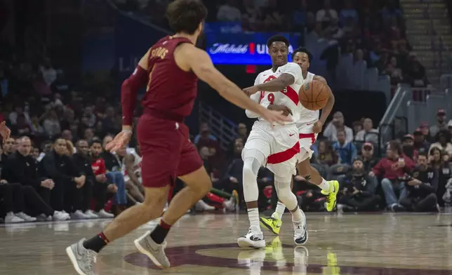 Toronto Raptors' RJ Barrett (9) loses his grip on the ball as Cleveland Cavaliers' Cleveland Cavaliers' Max Strus,left, moves in during the first half of an NBA basketball game in Cleveland, Thursday, Jan. 9, 2025. (AP Photo/Phil Long)