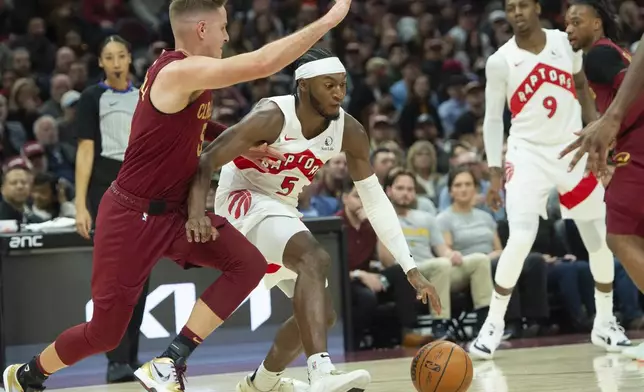 Toronto Raptors' Immanuel Quickley (5) drives past Cleveland Cavaliers' Sam Merrill, left, as RJ Barrett (9) and Darius Garland, right, watch during the first half of an NBA basketball game in Cleveland, Thursday, Jan. 9, 2025. (AP Photo/Phil Long)