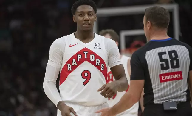 Toronto Raptors' RJ Barrett (9) talks with referee Josh Tiven (58) after being called for a technical foul against the Cleveland Cavaliers during the first half of an NBA basketball game in Cleveland, Thursday, Jan. 9, 2025. (AP Photo/Phil Long)