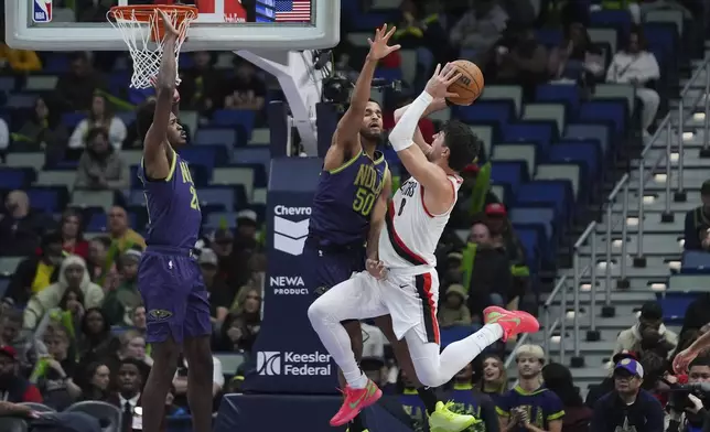 Portland Trail Blazers forward Deni Avdija (8) is fouled by New Orleans Pelicans forward Jeremiah Robinson-Earl (50) as he drives to the basket in the second half of an NBA basketball game in New Orleans, Wednesday, Jan. 8, 2025. (AP Photo/Gerald Herbert)