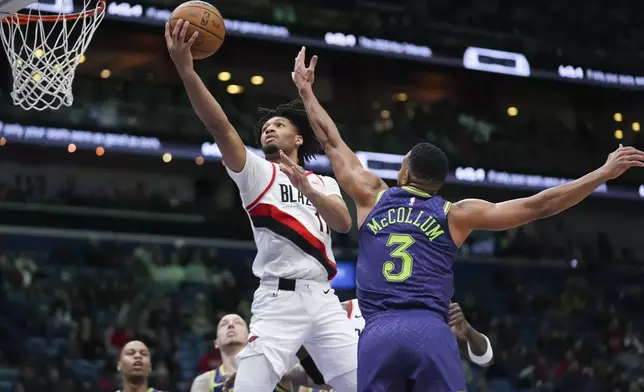 Portland Trail Blazers guard Shaedon Sharpe goes to the basket against New Orleans Pelicans guard CJ McCollum (3) in the first half of an NBA basketball game in New Orleans, Wednesday, Jan. 8, 2025. (AP Photo/Gerald Herbert)