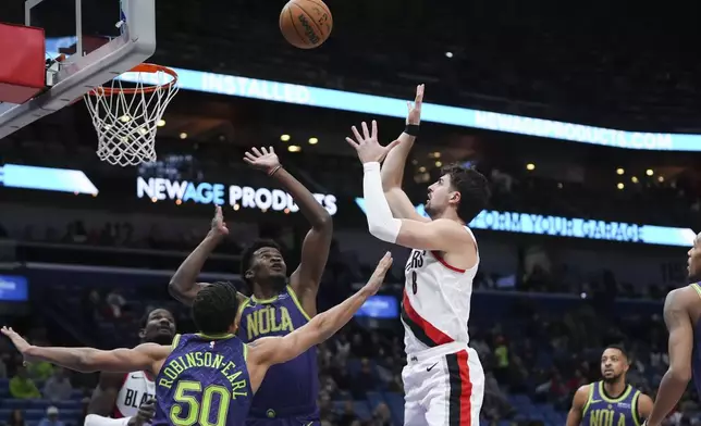 Portland Trail Blazers forward Deni Avdija (8) shoots against New Orleans Pelicans center Yves Missi and forward Jeremiah Robinson-Earl (50) in the first half of an NBA basketball game in New Orleans, Wednesday, Jan. 8, 2025. (AP Photo/Gerald Herbert)