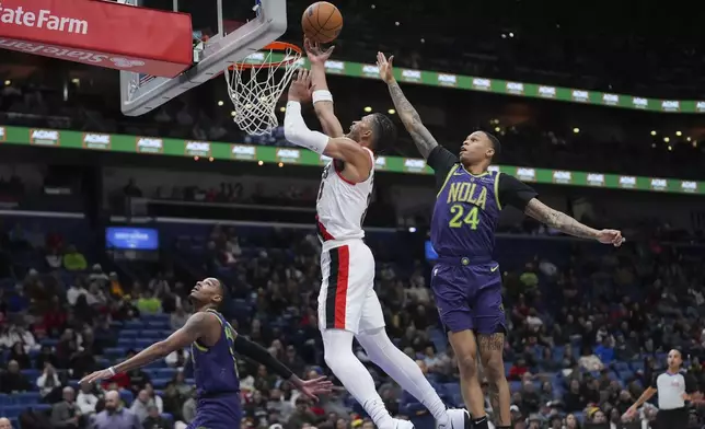 Portland Trail Blazers forward Toumani Camara (33) goes to the basket against New Orleans Pelicans guard Jordan Hawkins (24) in the first half of an NBA basketball game in New Orleans, Wednesday, Jan. 8, 2025. (AP Photo/Gerald Herbert)