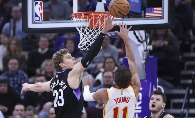 Utah Jazz forward Lauri Markkanen (23) blocks the shot of Atlanta Hawks guard Trae Young (11) during the fourth quarter of an NBA basketball game, Tuesday, Jan. 7, 2025, in Salt Lake City. (AP Photo/Rob Gray)