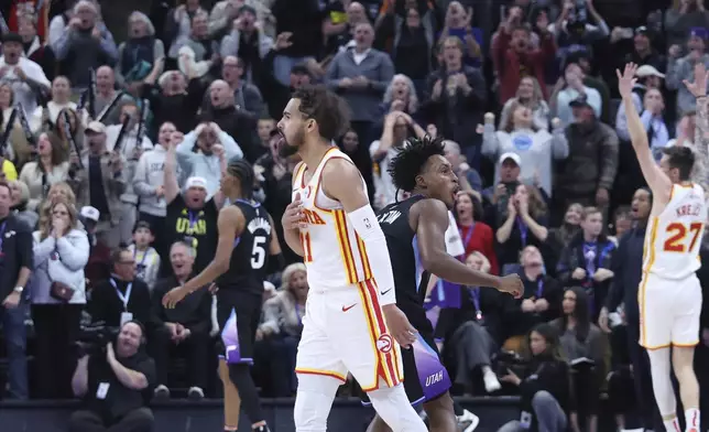 Atlanta Hawks guard Trae Young reacts to a game winning half court shot against the Utah Jazz during an NBA basketball game, Tuesday, Jan. 7, 2025, in Salt Lake City. (AP Photo/Rob Gray)