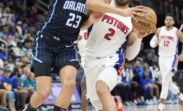 Detroit Pistons guard Cade Cunningham (2) drives as Orlando Magic forward Tristan da Silva (23) defends during the first half of an NBA basketball game, Wednesday, Jan. 1, 2025, in Detroit. (AP Photo/Carlos Osorio)