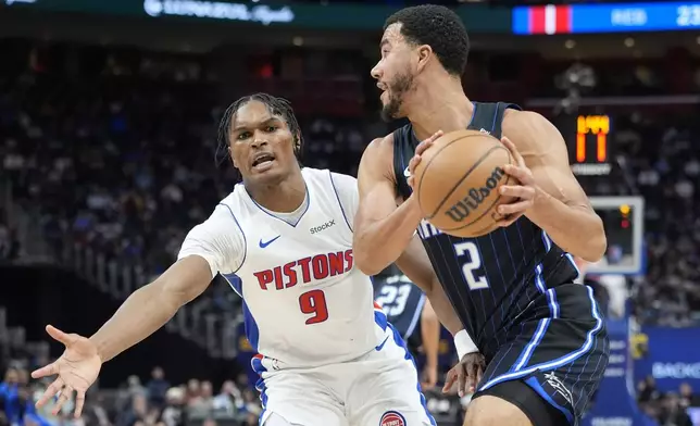 Orlando Magic guard Caleb Houstan (2) looks to pass as Detroit Pistons forward Ausar Thompson (9) defends during the first half of an NBA basketball game, Wednesday, Jan. 1, 2025, in Detroit. (AP Photo/Carlos Osorio)