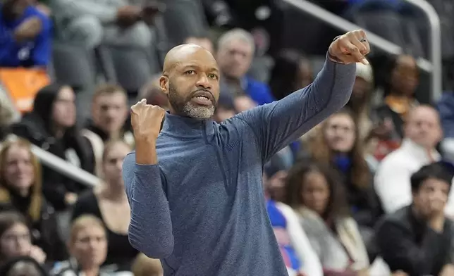 Orlando Magic head coach Jamahl Mosley signals during the first half of an NBA basketball game against the Detroit Pistons, Wednesday, Jan. 1, 2025, in Detroit. (AP Photo/Carlos Osorio)