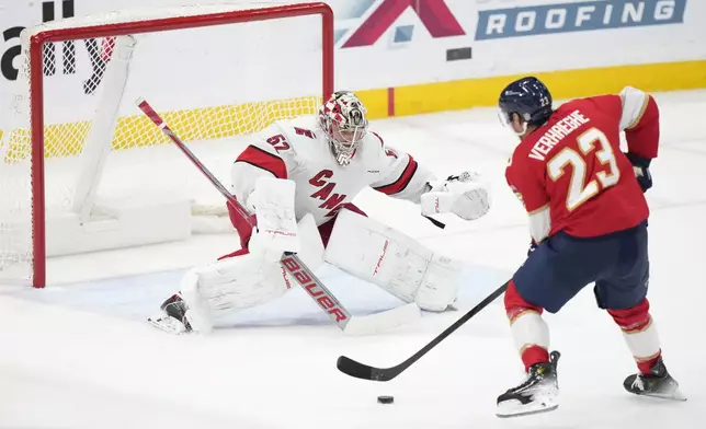 Florida Panthers center Carter Verhaeghe (23) attempts a shot against Carolina Hurricanes goaltender Pyotr Kochetkov (52) during the first period of an NHL hockey game, Thursday, Jan. 2, 2025, in Sunrise, Fla. (AP Photo/Wilfredo Lee)