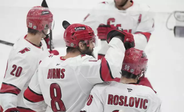 Carolina Hurricanes defenseman Brent Burns (8) celebrates with teammates after scoring during the first period of an NHL hockey game against the Florida Panthers, Thursday, Jan. 2, 2025, in Sunrise, Fla. (AP Photo/Wilfredo Lee)