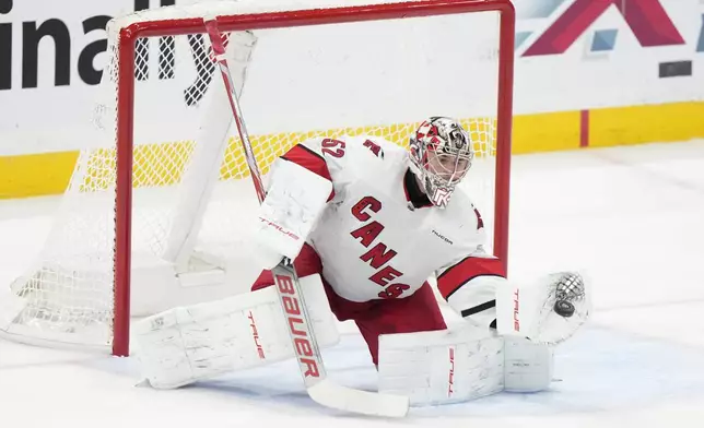 Carolina Hurricanes goaltender Pyotr Kochetkov makes a save during the first period of an NHL hockey game against the Florida Panthers, Thursday, Jan. 2, 2025, in Sunrise, Fla. (AP Photo/Wilfredo Lee)