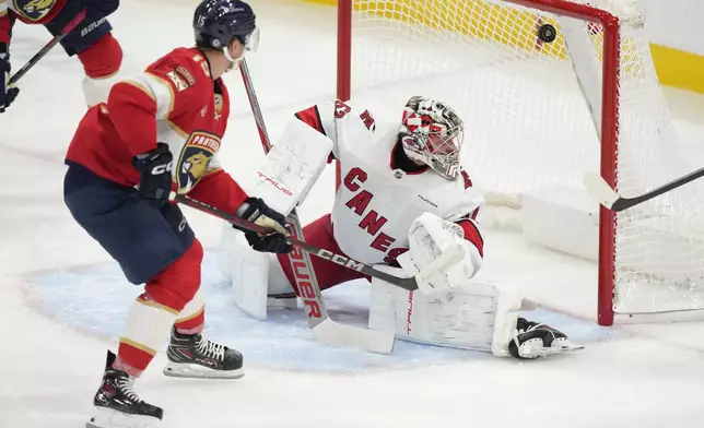 Florida Panthers center Anton Lundell (15) scores against Carolina Hurricanes goaltender Pyotr Kochetkov (52) during the second period of an NHL hockey game, Thursday, Jan. 2, 2025, in Sunrise, Fla. (AP Photo/Wilfredo Lee)