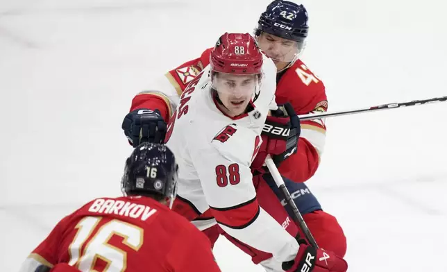 Carolina Hurricanes center Martin Necas (88) skates against Florida Panthers center Aleksander Barkov (16) and defenseman Gustav Forsling (42) during the first period of an NHL hockey game, Thursday, Jan. 2, 2025, in Sunrise, Fla. (AP Photo/Wilfredo Lee)