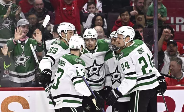Dallas Stars' Jason Robertson (21) celebrates after his goal against the Ottawa Senators with teammates during first-period NHL hockey game action in Ottawa, Ontario, Sunday, Jan. 12, 2025. (Justin Tang/The Canadian Press via AP)