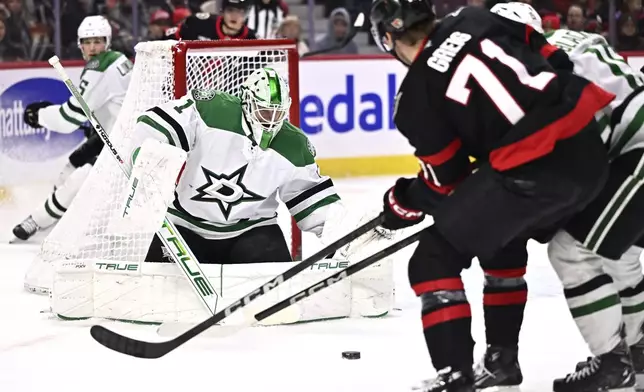 Dallas Stars goaltender Casey DeSmith (1) makes a save against Ottawa Senators' Ridly Greig (71) during second-period NHL hockey game action in Ottawa, Ontario, Sunday, Jan. 12, 2025. (Justin Tang/The Canadian Press via AP)