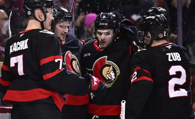 Ottawa Senators' Josh Norris (9) celebrates after his goal with teammates Brady Tkachuk (7), Drake Batherson (19), Thomas Chabot (72) and Artem Zub (2) during second-period NHL hockey game action against the Dallas Stars in Ottawa, Ontario, Sunday, Jan. 12, 2025. (Justin Tang/The Canadian Press via AP)
