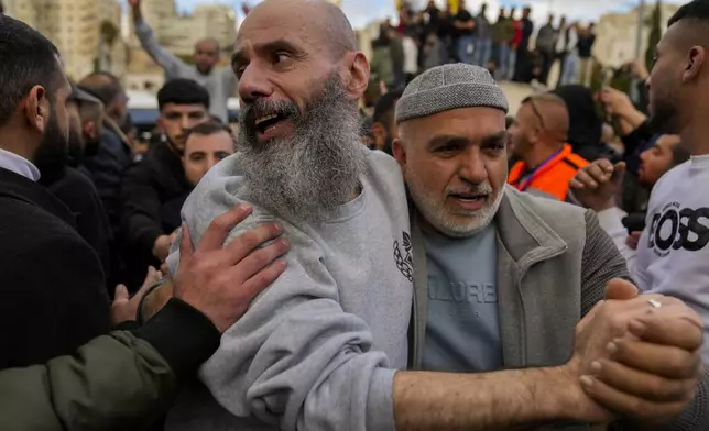 Palestinian prisoners are greeted by a crowd after being released from Israeli prison following a ceasefire agreement with Israel, in the West Bank city of Ramallah, Saturday, Jan. 25, 2025. (AP Photo/Nasser Nasser)