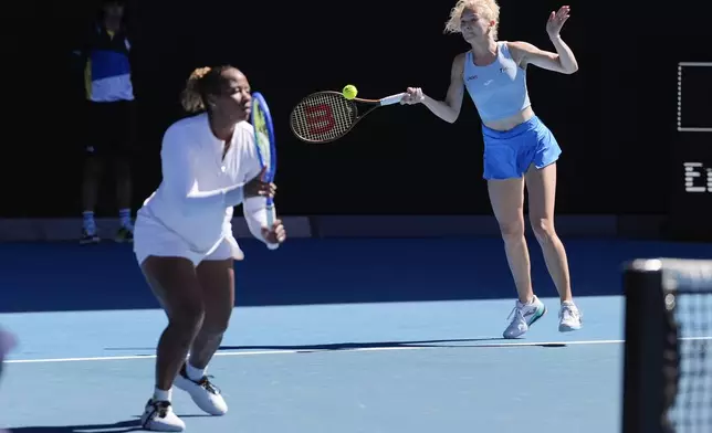 Katerina Sinikova, right, of the Czech Republic and Taylor Townsend of the U.S. in action against Hsieh Su-Wei of Taiwan and Jelena Ostapenko of Latvia in the women's doubles final at the Australian Open tennis championship in Melbourne, Australia, Sunday, Jan. 26, 2025. (AP Photo/Asanka Brendon Ratnayake)