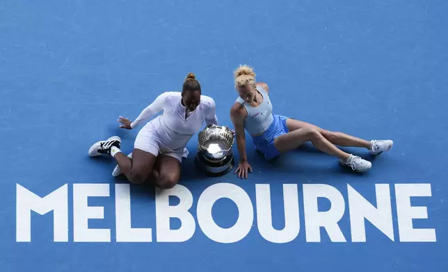 Katerina Sinikova of the Czech Republic and Taylor Townsend of the U.S. pose with their trophy after defeating Hsieh Su-Wei of Taiwan and Jelena Ostapenko of Latvia in the women's doubles final at the Australian Open tennis championship in Melbourne, Australia, Sunday, Jan. 26, 2025. (AP Photo/Manish Swarup)