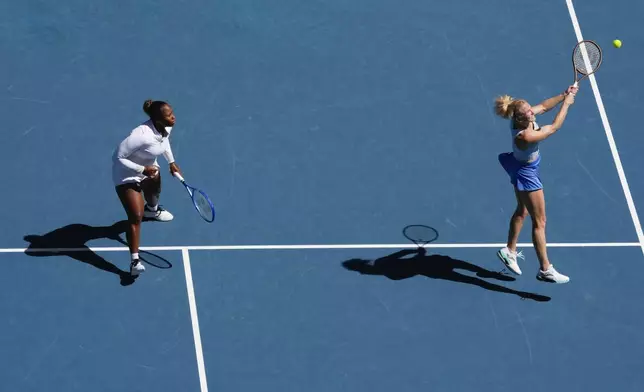 Katerina Sinikova, right, of the Czech Republic and Taylor Townsend of the U.S. in action against Hsieh Su-Wei of Taiwan and Jelena Ostapenko of Latvia in the women's doubles final at the Australian Open tennis championship in Melbourne, Australia, Sunday, Jan. 26, 2025. (AP Photo/Manish Swarup)