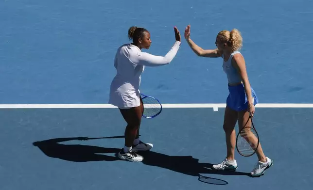 Katerina Sinikova, right, of the Czech Republic and Taylor Townsend of the U.S. in action against Hsieh Su-Wei of Taiwan and Jelena Ostapenko of Latvia in the women's doubles final at the Australian Open tennis championship in Melbourne, Australia, Sunday, Jan. 26, 2025. (AP Photo/Manish Swarup)
