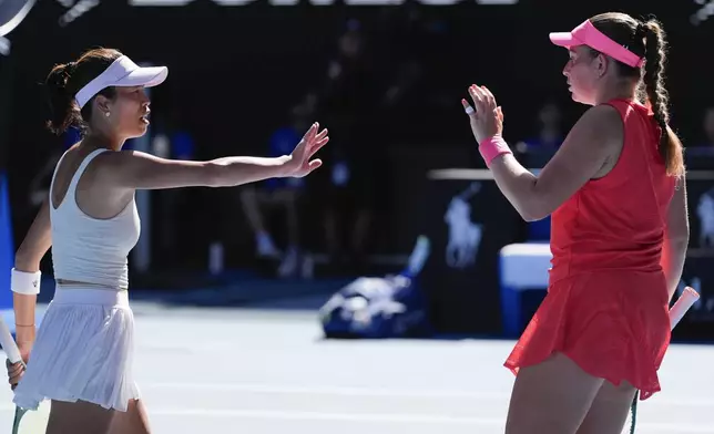 Hsieh Su-Wei, left, of Taiwan and Jelena Ostapenko of Latvia in action against Katerina Sinikova of Czech Republic and Taylor Townsend of the U.S. at the Australian Open tennis championship in Melbourne, Australia, Sunday, Jan. 26, 2025. (AP Photo/Asanka Brendon Ratnayake)