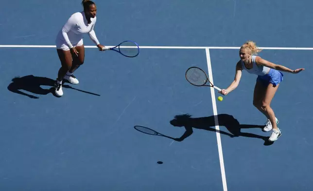 Katerina Sinikova, right, of the Czech Republic and Taylor Townsend of the U.S. in action against Hsieh Su-Wei of Taiwan and Jelena Ostapenko of Latvia in the women's doubles final at the Australian Open tennis championship in Melbourne, Australia, Sunday, Jan. 26, 2025. (AP Photo/Manish Swarup)