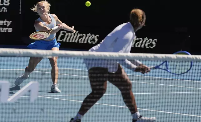 Katerina Sinikova, left, of the Czech Republic and Taylor Townsend of the U.S. in action against Hsieh Su-Wei of Taiwan and Jelena Ostapenko of Latvia in the women's doubles final at the Australian Open tennis championship in Melbourne, Australia, Sunday, Jan. 26, 2025. (AP Photo/Asanka Brendon Ratnayake)