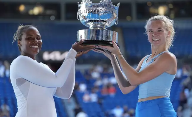 Katerina Sinikova, right, of the Czech Republic and Taylor Townsend of the U.S. hold their trophy aloft after defeating Hsieh Su-Wei of Taiwan and Jelena Ostapenko of Latvia in the women's doubles final at the Australian Open tennis championship in Melbourne, Australia, Sunday, Jan. 26, 2025.(AP Photo/Asanka Brendon Ratnayake)