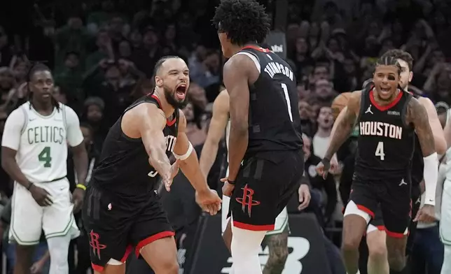 Houston Rockets forward Amen Thompson (1) is congratulated by Dillon Brooks, front left, after making the winning basket against the Boston Celtics in the final seconds of an NBA basketball game, Monday, Jan. 27, 2025, in Boston. (AP Photo/Charles Krupa)