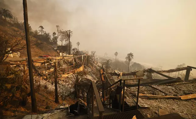 Homes damaged by the Palisades Fire are seen along the beach, Wednesday, Jan. 8, 2025, in Malibu, Calif. (AP Photo/Etienne Laurent)