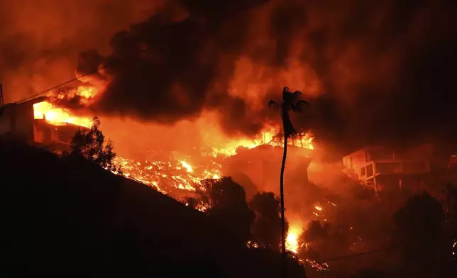 The Palisades Fire burns homes on a hilltop in the Pacific Palisades neighborhood of Los Angeles, Wednesday, Jan. 8, 2025. (AP Photo/Mark J. Terrill)