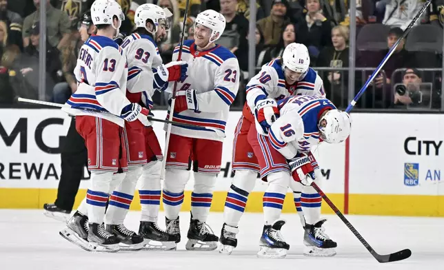 The New York Rangers celebrate after a goal by center Vincent Trocheck's (16) against the Vegas Golden Knights during the second period of an NHL hockey game Saturday, Jan. 11, 2025, in Las Vegas. (AP Photo/David Becker)