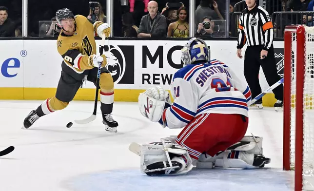 Vegas Golden Knights center Jack Eichel (9) shoots against New York Rangers goaltender Igor Shesterkin, front right, during the second period of an NHL hockey game Saturday, Jan. 11, 2025, in Las Vegas. (AP Photo/David Becker)