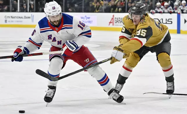 New York Rangers center Vincent Trocheck (16) looks to shoot against Vegas Golden Knights right wing Victor Olofsson (95) during the first period of an NHL hockey game Saturday, Jan. 11, 2025, in Las Vegas. (AP Photo/David Becker)