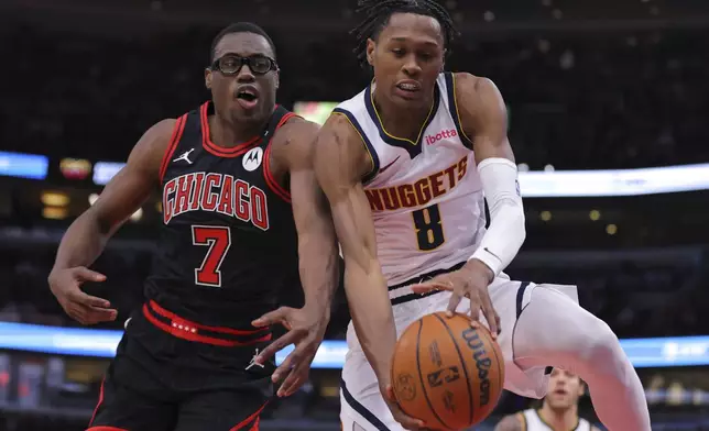Denver Nuggets forward Peyton Watson (8) grabs a rebound against Chicago Bulls forward Jalen Smith (7) during the first half of an NBA basketball game Monday, Jan. 27, 2025, in Chicago. (AP Photo/Melissa Tamez)